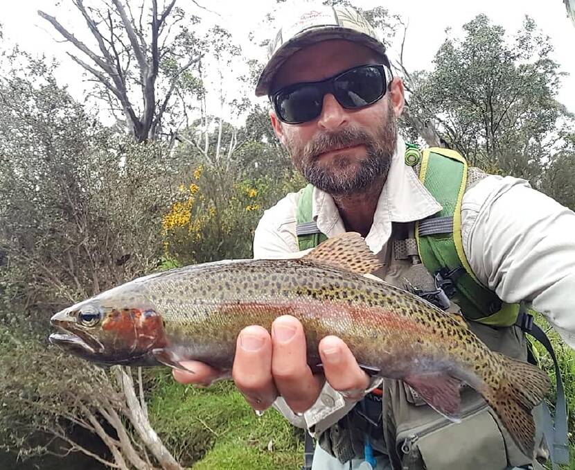  Brendon Spicer with an excellent coloured rainbow trout from the Bredbo River.