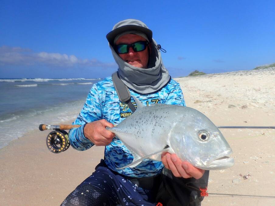 Beach beauty: Barry Gentle with a fly-caught tea leaf trevally. Email your high res fishing pictures to gazwade@bigpond.com