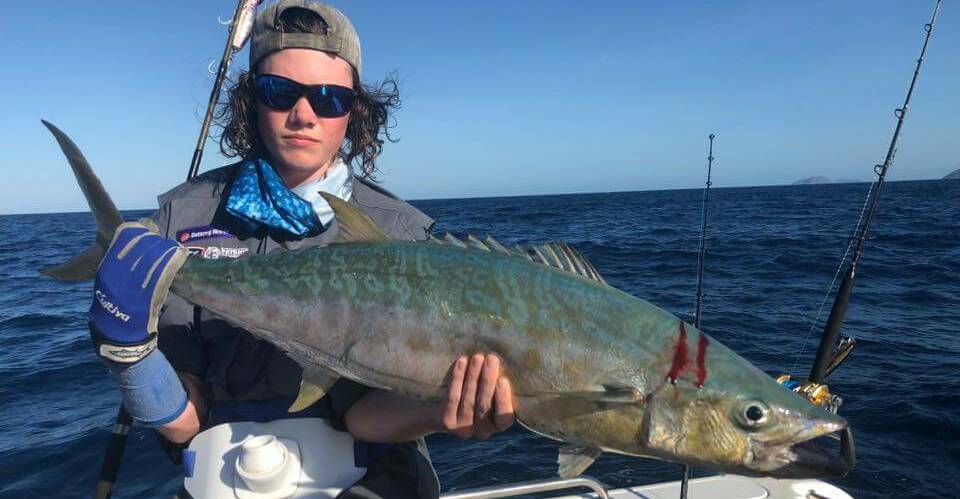 Fighting fish: Phill Taylor with his solid shark mackerel. The species is found near coral reefs along Australia's north-eastern and north-western coastlines.