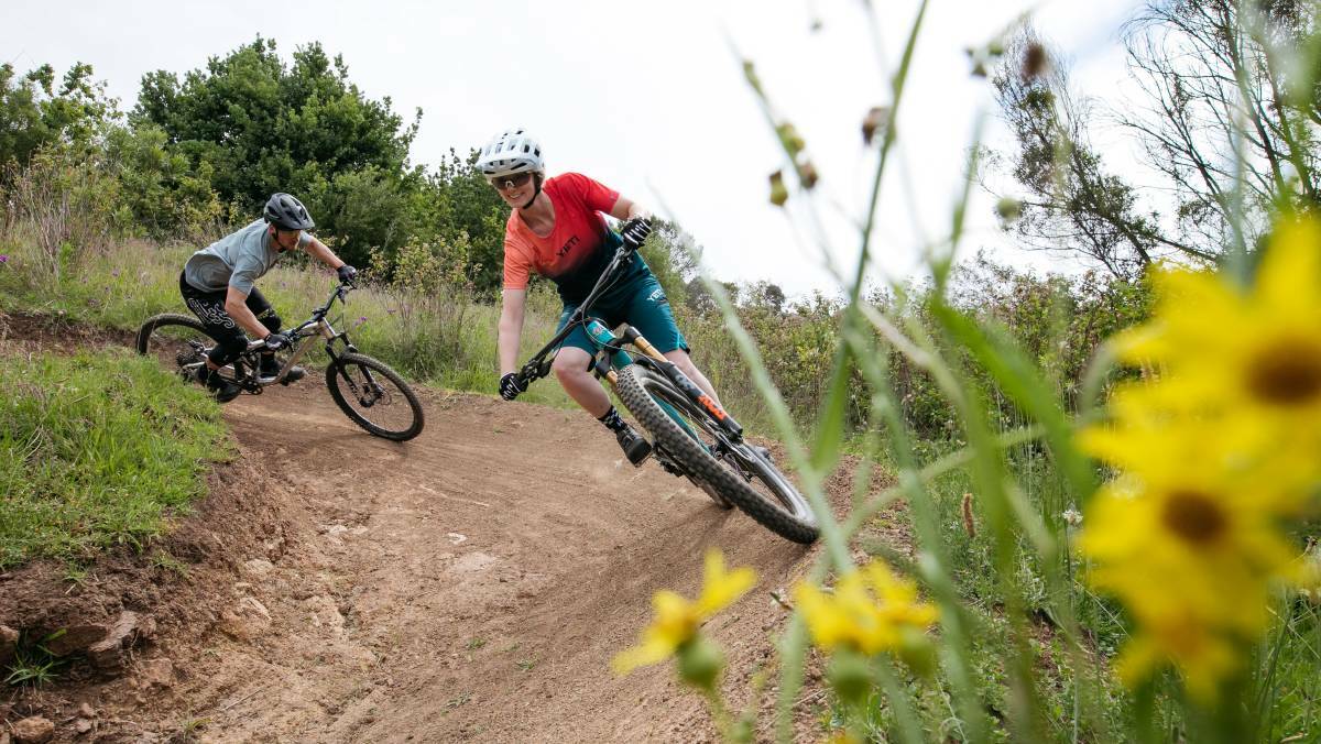 Wonderful city asset: Darcy Coutts and Leanna Curtis ride on Cringila Hills Recreation Park's mountain bike trails. Picture: Wesley Lonergan.