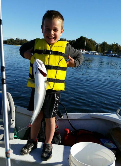 Six-year-old Zac Ritevski is elated with his salmon capture at Sussex Inlet.
