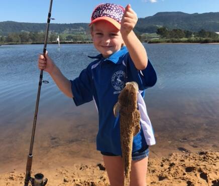 Petite Jindy McIlquham with her sizable flathead she caught recently.