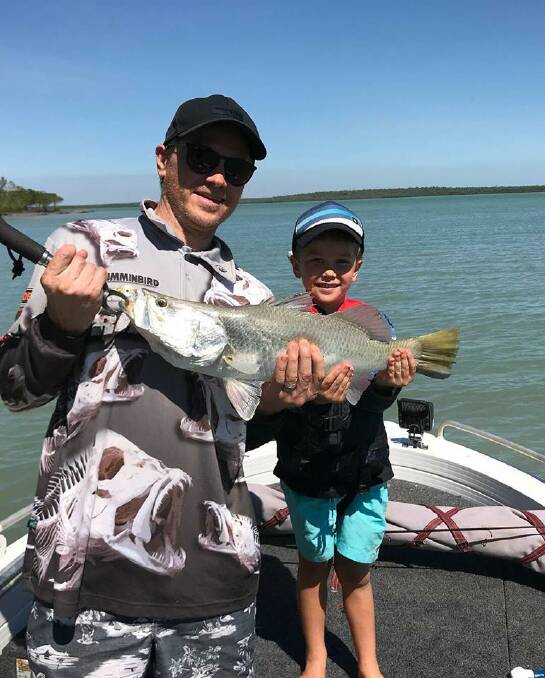 Father and son: Todd and Flynn Lloyd escaped the cold to fish up north for this nice barra for Flynn. In the Illawarra, winter weather is keeping many boats ashore.