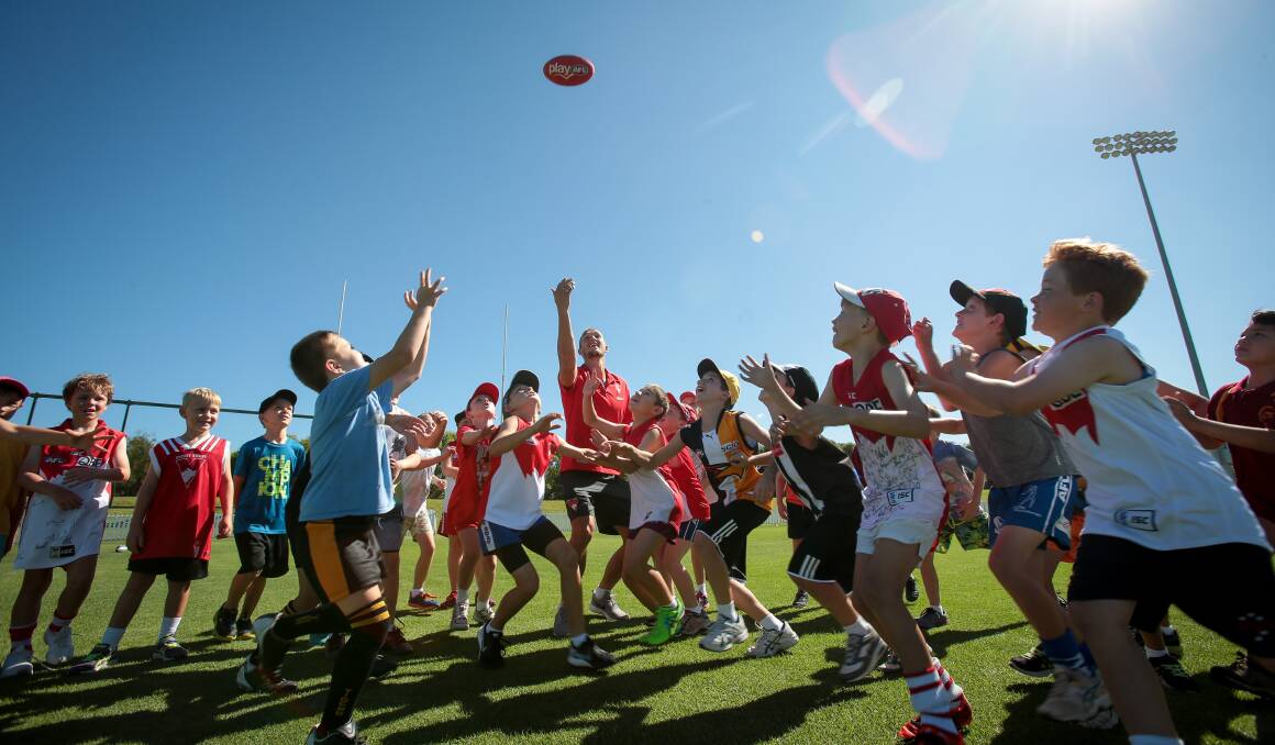 My ball: Swans premiership star Sam Reid throws up the footy at the Swans Community Camp at North Dalton Park. Picture: Adam McLean