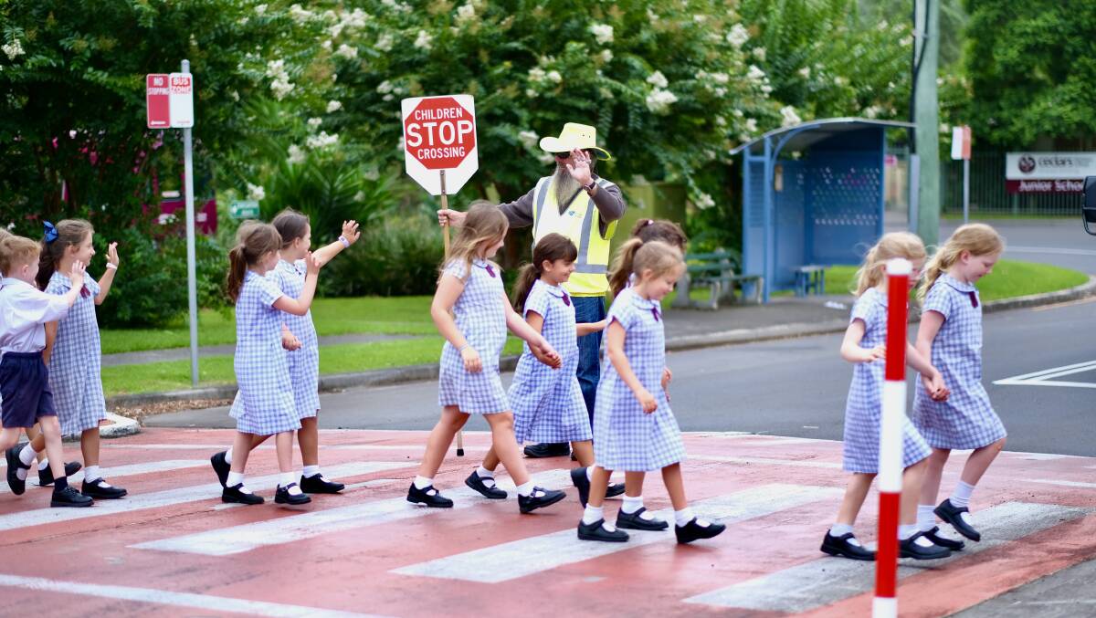 WAVING BYE: Cedars Christian College students wave goodbye to departing crossing guard Eric Brown.