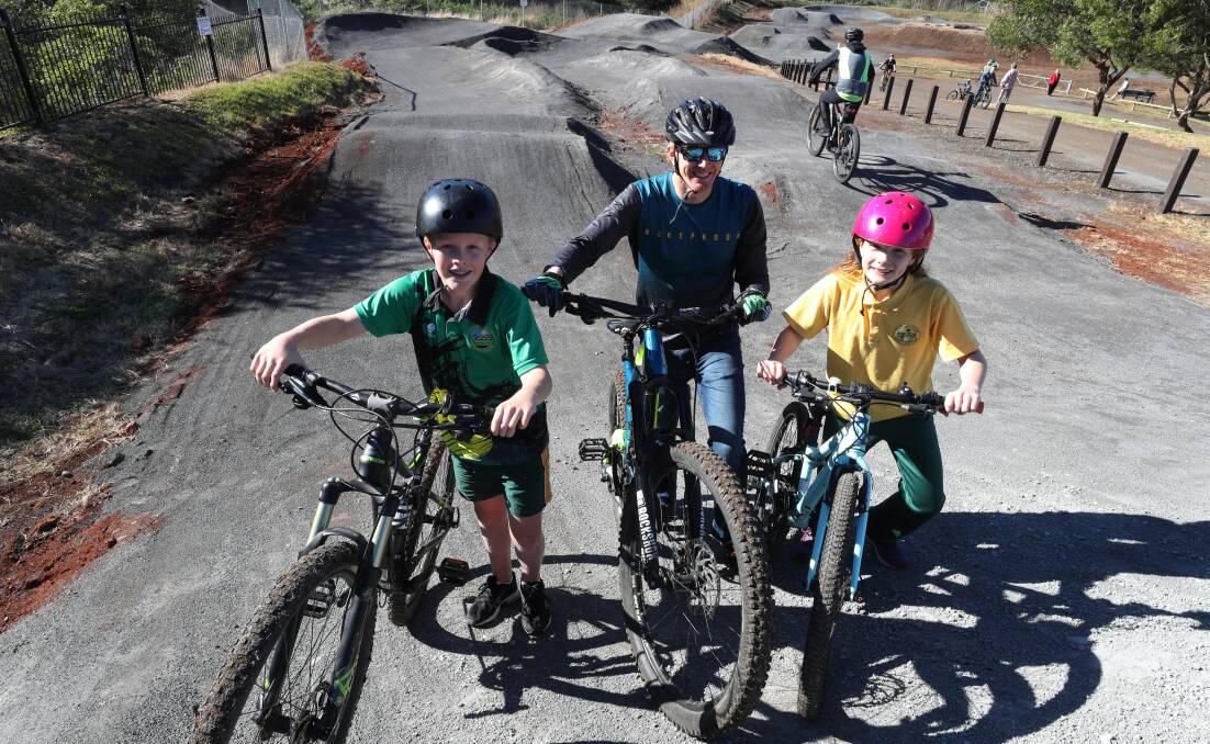 GOOD RESULT: Michael Thompson with his children Luke and Lucy at the new Minnamurra Bike Skills Track. Picture: Robert Peet
