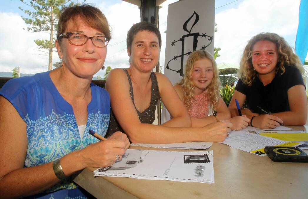 WRITING WRONGS: Amnesty International Wollongong members Jane Cipants, Katrina Henze, Claudia and Alice Gill, who will be at Bulli Beach Cafe on May 28