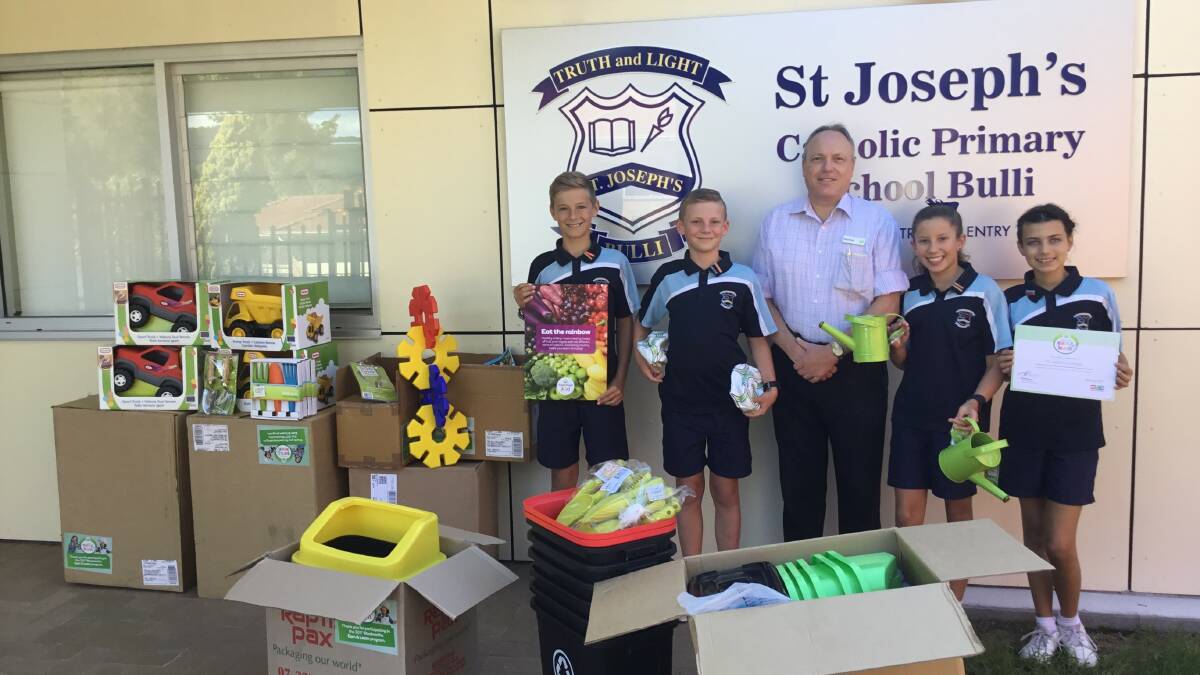 LUCKY SCHOOL: St Joseph's Catholic Primary School representatives Daniel Campbell, Manfred, Carolyn Watkins and Tallulah Rogers collect their earn & learn equipment from Woolworths Bulli store manager Kirk Mathis.