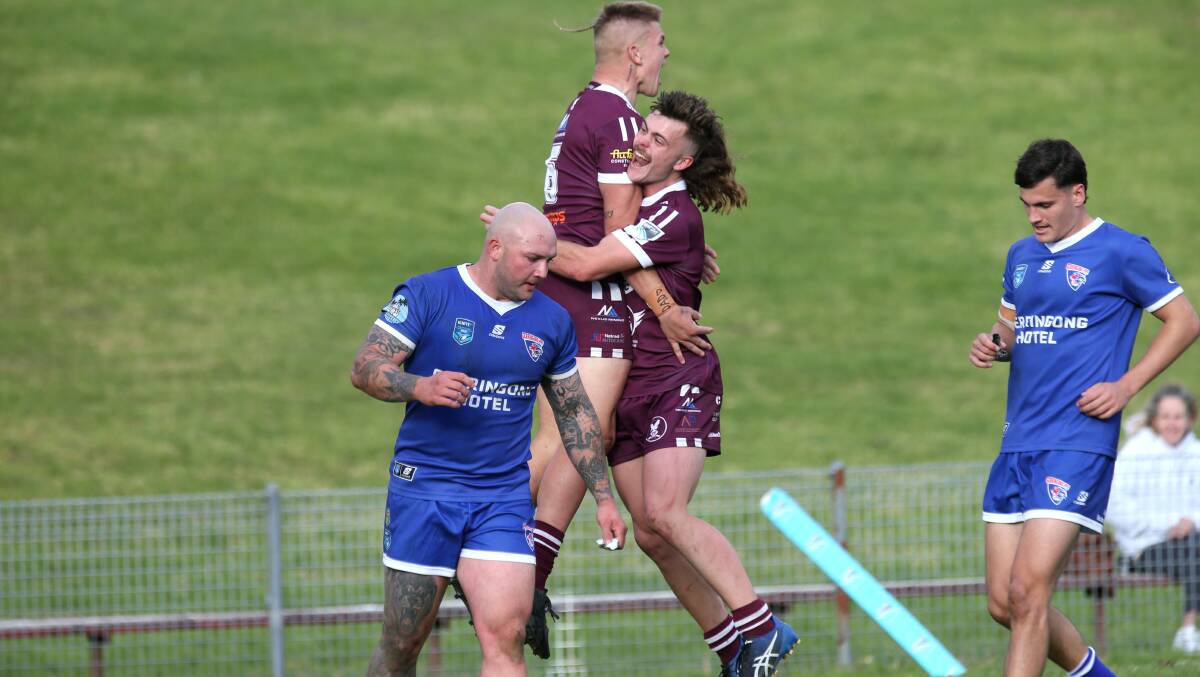 Albion Park-Oak Flats Eagles fullback Jesse Prinsse lifts up team-mate James Walsh after the five-eighth scored a spectacular solo try in his team's 36-32 win over Gerringong Lions. Picture by Sylvia Liber