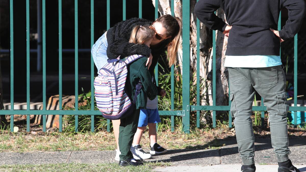 Amanda Matruglio kissing her daughter Mackenzie Matruglio outside Russell Vale Public School on Monday, May 11. Picture: Robert Peet