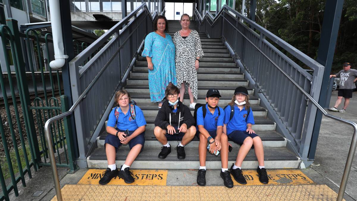 TRAIN CHAOS: Kate Garrard and Carenne Karavakula with Bulli High School year 7 students Jasper, Madden, Isaiah and Kaelan after their first day at high school. at Helensburgh train station. Picture: Robert Peet. 