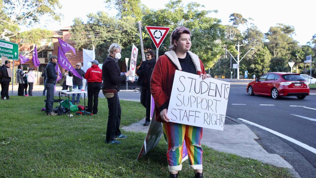SIGN OF TIMES: Wollongong Undergraduate Student Association (WUSA) education officer Robin Pierson showed her support for staff. Picture: Adam McLean