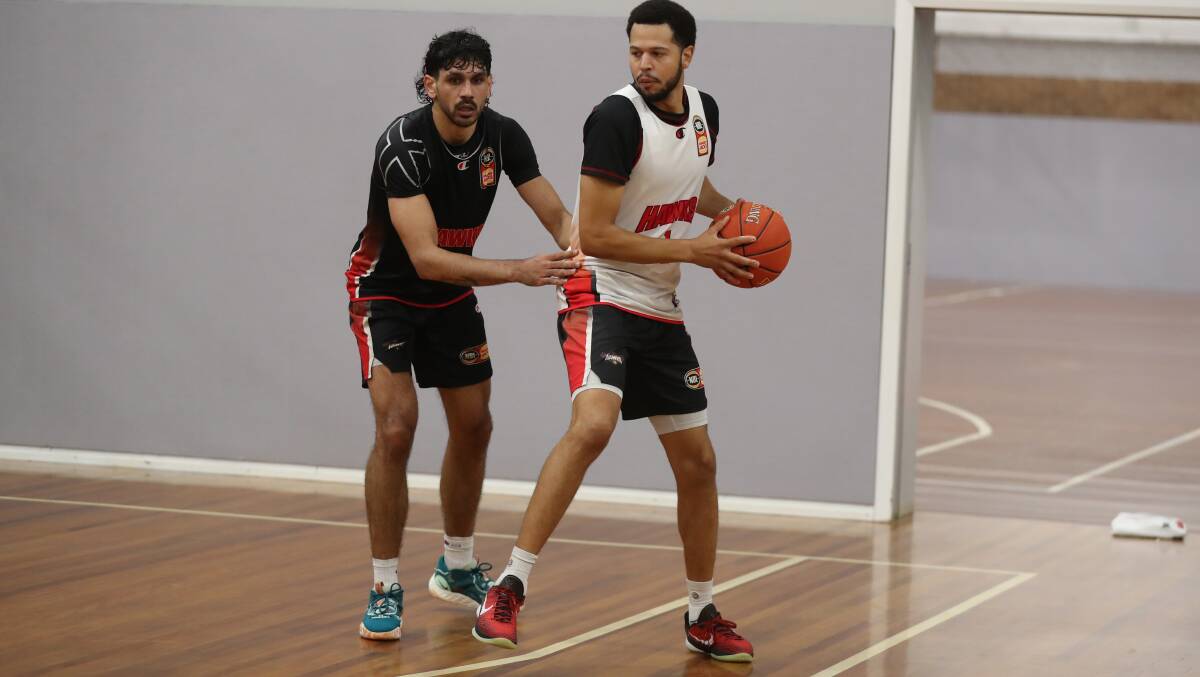 Illawarra Hawks guard Tyler Harvey guarded by Will Hickey during practice at the Snakepit on Tuesday. Picture by Robert Peet