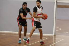 Illawarra Hawks guard Tyler Harvey guarded by Will Hickey during practice at the Snakepit on Tuesday. Picture by Robert Peet