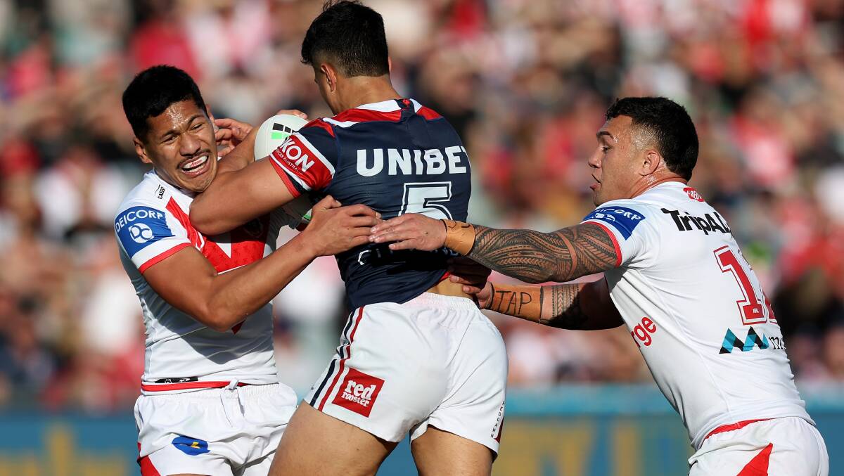 HARD TO HANDLE: St George Illawarra Dragons pair Talatau Amone and Jaydn Su'A try to tackle Roosters winger Joseph Suaalii. Picture: Getty Images