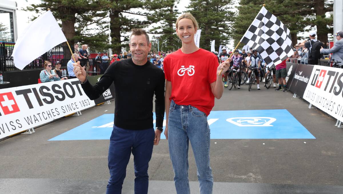UCI Road World Championships ambassadors Cadel Evans and Emma McKeon flag the start of the community ride in Wollongong on Saturday. Picture: Adam McLean