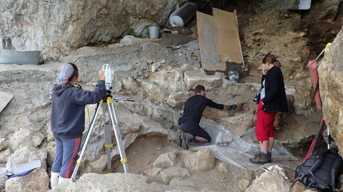 DIGGING DEEP: The team complete excavations of archaeological deposits in Chagyrskaya Cave. Picture: Richard Roberts