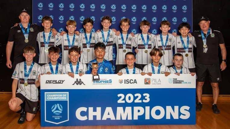 Balgownie U14 boys celebrate winning the 2023 Champion of Champions tournament.