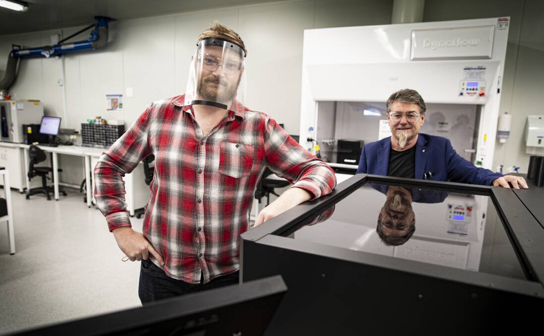 BREAKTHROUGH: Distinguished Professor Gordon Wallace (blue suit) and additive fabrication technician Cameron Angus at UOW's Translational Research Initiative for Cell Engineering and Printing (TRICEP) facility. Pictures: Paul Jones 