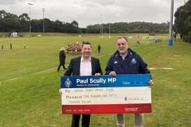 Member for Wollongong Paul Scully presents a $150,000 check to Vikings Rugby Club president Spiro Lozenkowski. Picture supplied