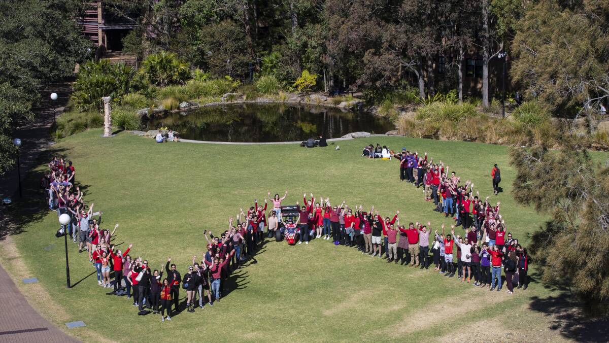 MEDCUP BATTLE: University of Wollongong students and staff lined-up and made a big W sign on Monday as part of a competition. Picture: Paul Jones