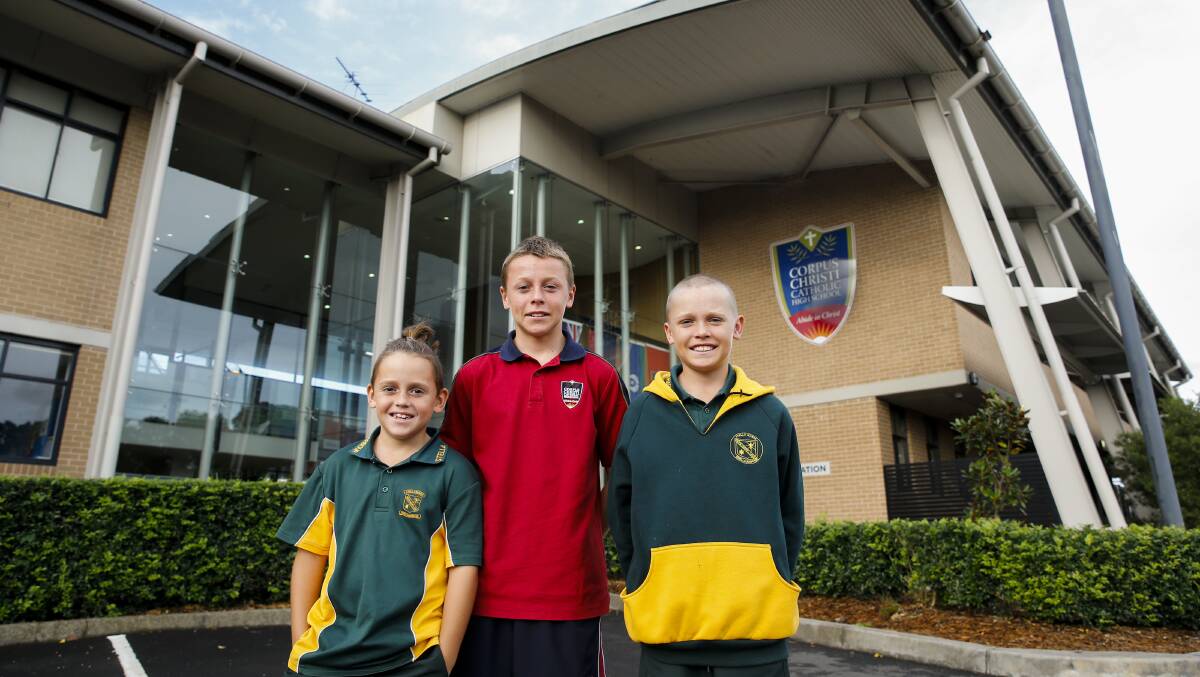 FAMILY: Shellharbour siblings Torren (green shirt), Kash red shirt) and Rize Smith (yellow and green jumper) at Corpus Christi Catholic High School, Oak Flats. Picture: Anna Warr