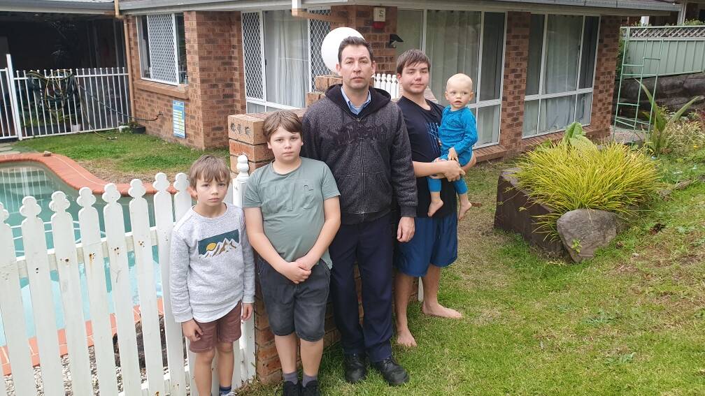 John Balzan and his children outside their Taminga Crescent house after the bungled home invasion.