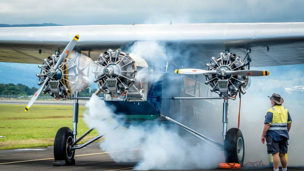 SMOKING: The magnificently restored replica of Smithys famous Southern Cross undergoes a spectacular run of its Jacobs radial motors under the careful eyes of volunteers at HARS Aviation Museum. Picture: Howard Mitchell