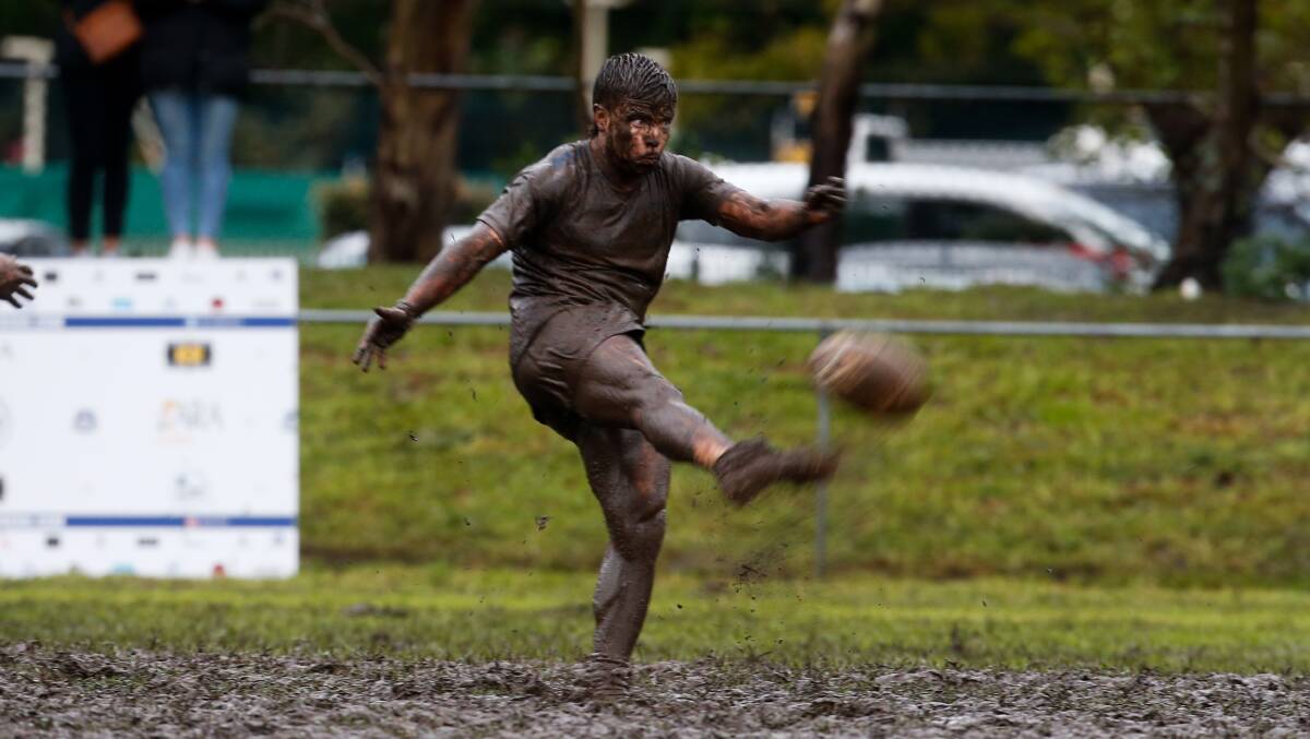MUD BATH: A Thirroul Butchers player, recognisable only to his family, at Thomas Gibson Park. Picture: Anna Warr