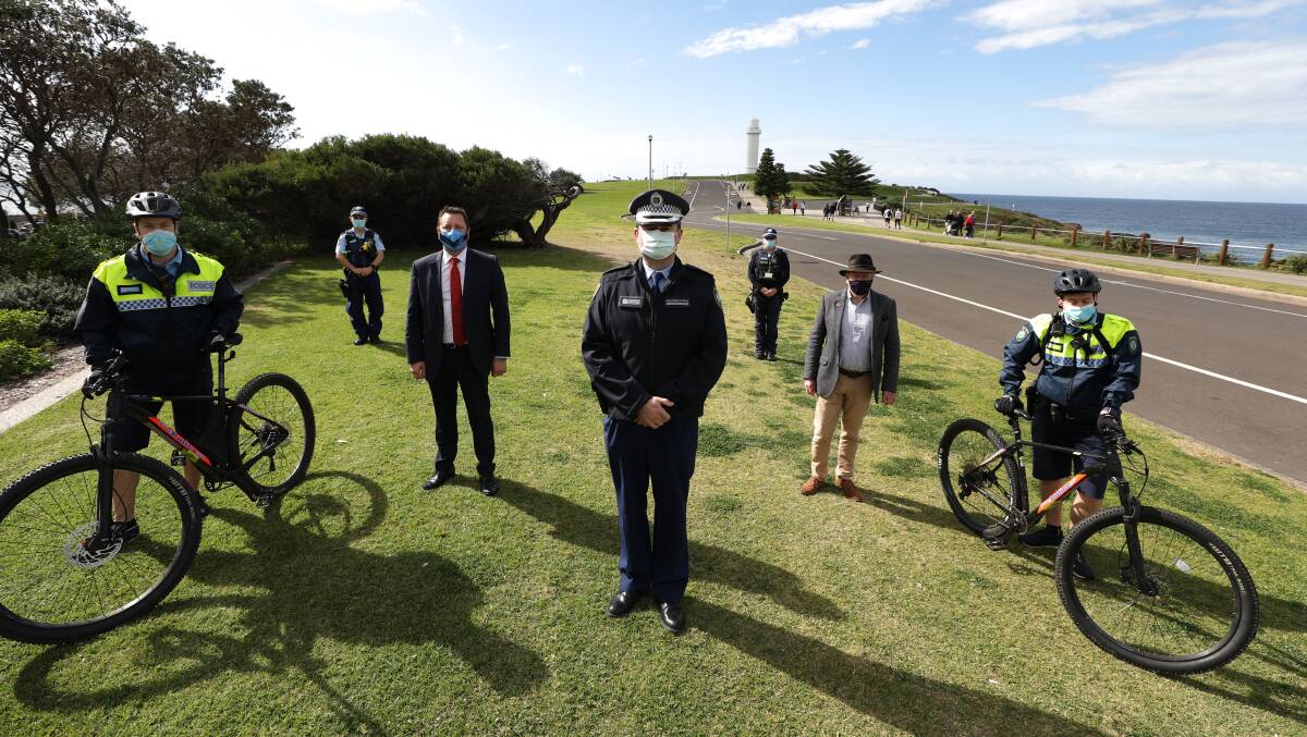 COMPLIANCE: Wollongong Police district commander Superintendent Evan Quarmby (centre) and other police officers joined by Member for Wollongong Paul Scully and Wollongong Lord Mayor Gordon Bradbery at Flagstaff Point, Wollongong. Picture: Adam Mclean 