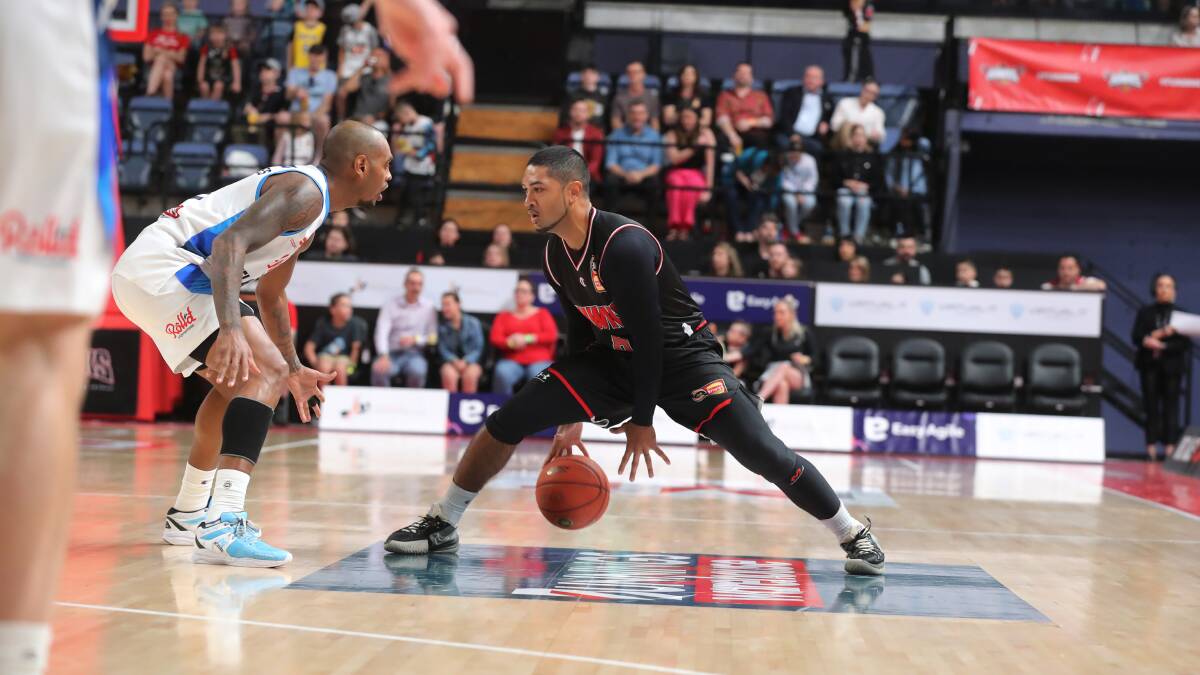 Peyton Siva tries to get past Melbourne United guard Xavier Rathan-Mayes. Former Hawk Mayes hit 32 points in United's 106-100 double-overtime win on Saturday. Picture: Robert Peet 