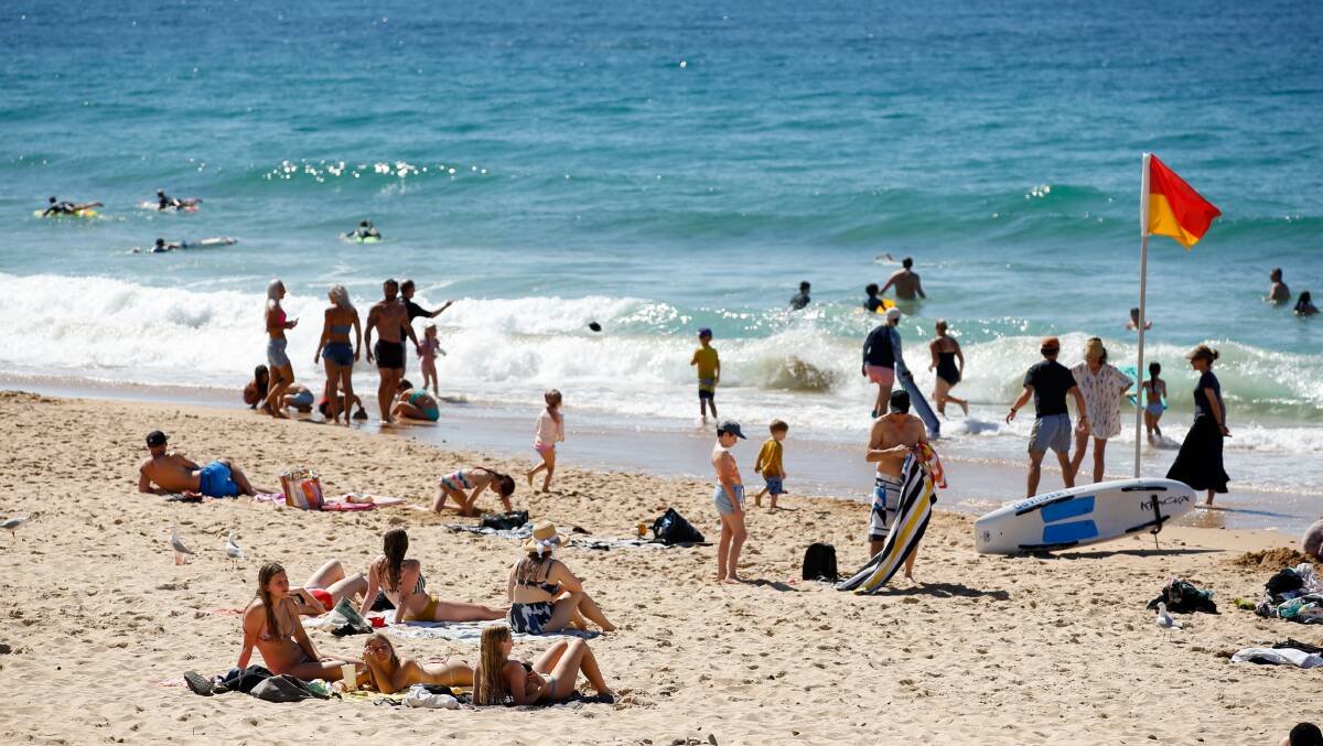 NORTH WOLLONGONG BEACH: Sunday's hot weather saw many head to the beach, with some lingering to sunbake in spite of current lockdown rules. Picture: Anna Warr