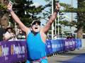 Kerry Dowling celebrates winning the 75-79 age-group category of the Peoplecare Triathlon in Wollongong on Sunday. Picture by Sylvia Liber