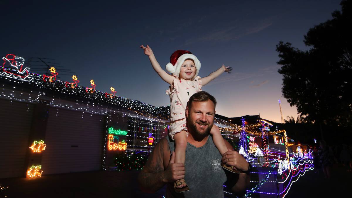 HAPPY: Zac Geoghegan with his daughter Indie checking out the Christmas lights display at Stubbs Road in Albion Park. Picture: Sylvia Liber
