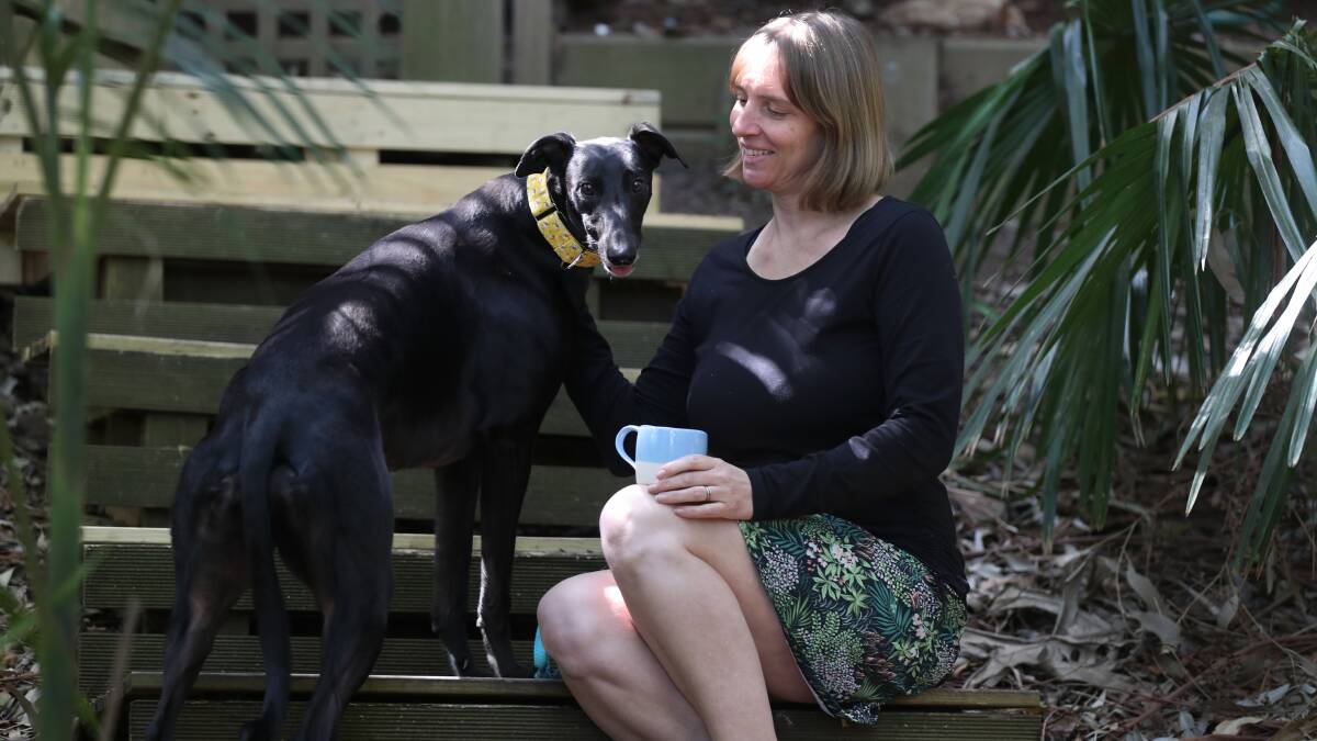 FREEDOM: Bulli mum Ange Milthorpe with her dog Hetty Bear chilling out in the garden now that kids are back at school. Picture: Robert Peet