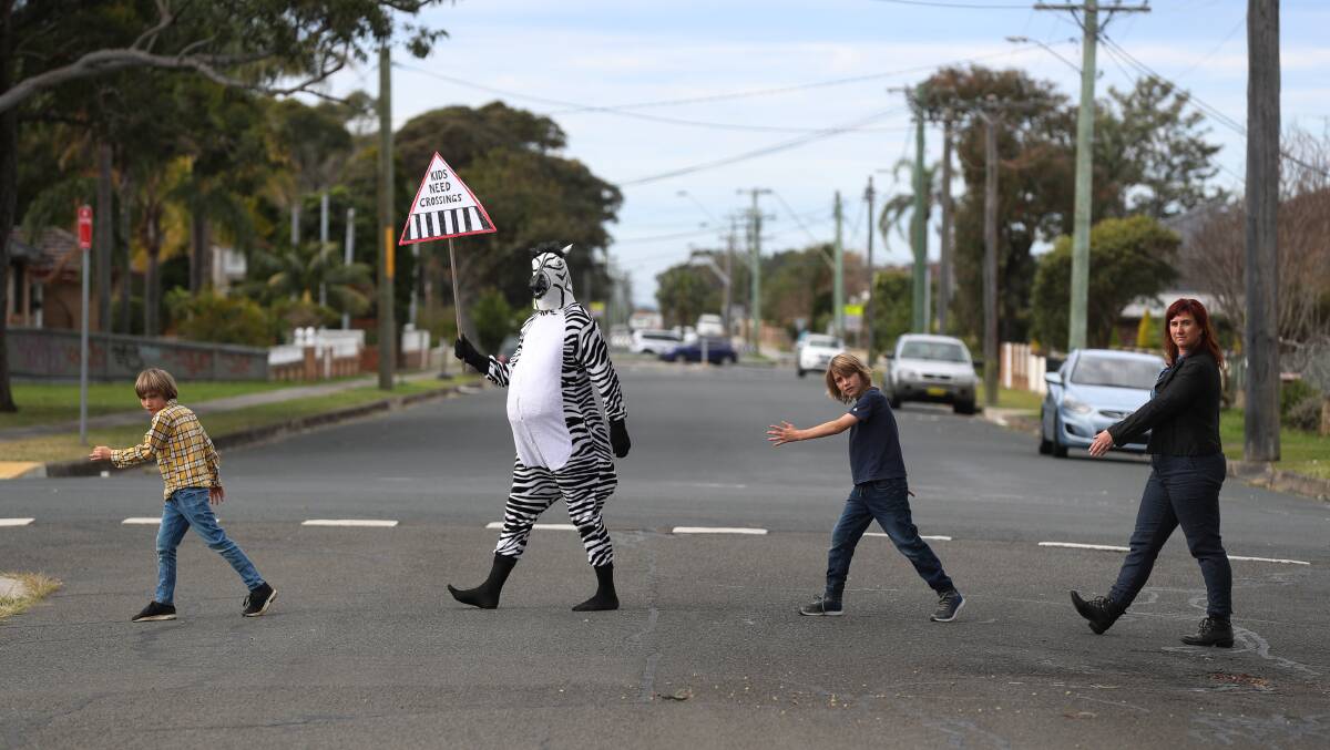 WALK THIS WAY: Debra the Zebra with Wollongong councillor Mithra Cox and her kids Perun Cubby and Griffin Cubby. Picture: Robert Peet