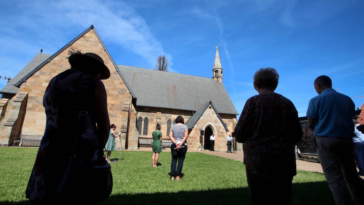 PUBLIC PRAYER: People taking part in a public prayer outside St Michael's Anglican Cathedral Wollongong kept their 'social distance'. Picture: Sylvia Liber.