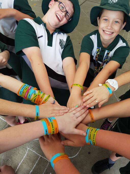 ALL TOGETHER: Albion Park Public School students show some of the wristbands they've worn to support National Day of Action Against Bullying & Violence.  