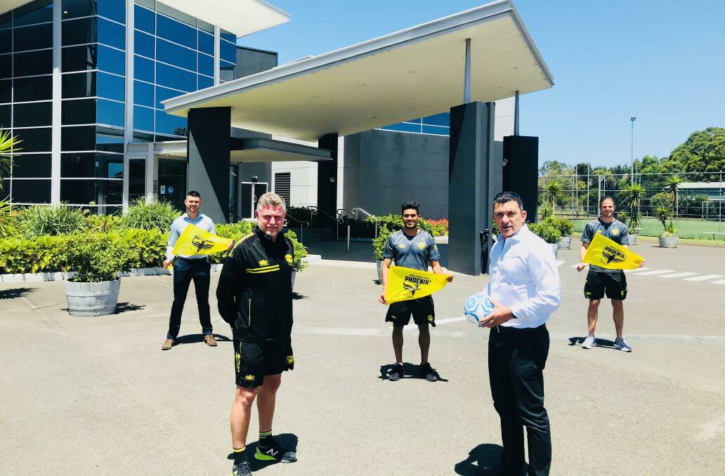 HOME OF FOOTBALL Wellington Phoenix coach Ufuk Talay and Fraternity Club president Mick Cuda with staff and players. Picture: Nathan Simpson