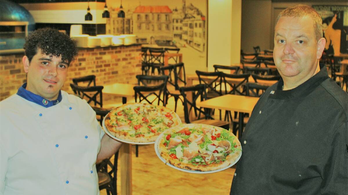 TASTY PIZZAS: Fraternity Club pizza chef Danilo Rossello (left) and chef Mauri Villella. The new pizza restaurant is winning the hearts and taste buds of diners.