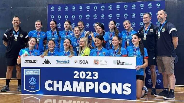 Shellharbour U18 women celebrate winning the 2023 Champion of Champions football tournament.