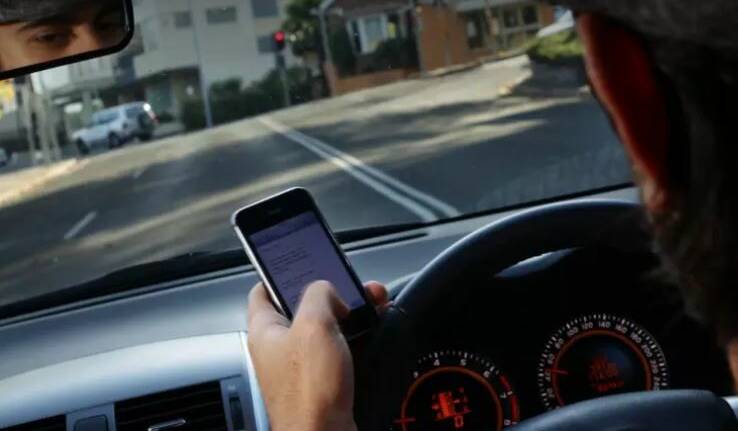 Drivers will lose five points for illegal use of a mobile phone. Picture: Ken Robertson