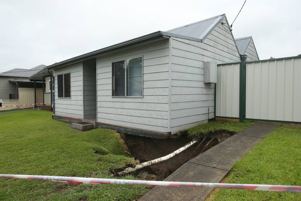 A second sinkhole opened at a home on Platt Street on Monday, undermining part of the building and driveway, exposing underground pipes. Picture by Simone De Peak