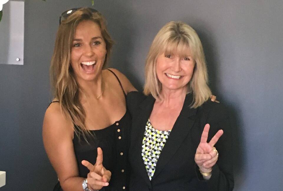 SURPRISE: Michelle Lay from Ray White Kiama got a surprise on Wednesday when pro-surfer Sally Fitzgibbons popped in to say thank you for selling her Minnamurra home. Picture: Ray White Kiama FACEBOOK