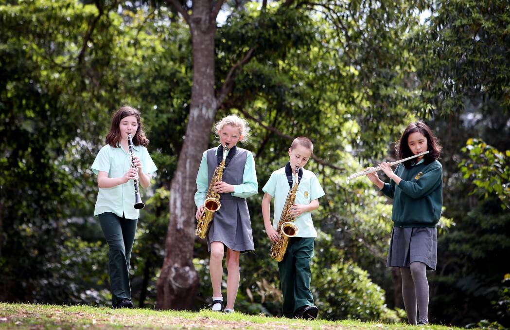 BLAST FROM THE PAST: Keiraville Public School students Kate Hood, Lily Tonge, Sam Di Leva and Anh Tran prepare for the school band's 125th anniversary performance. Picture: Sylvia Liber