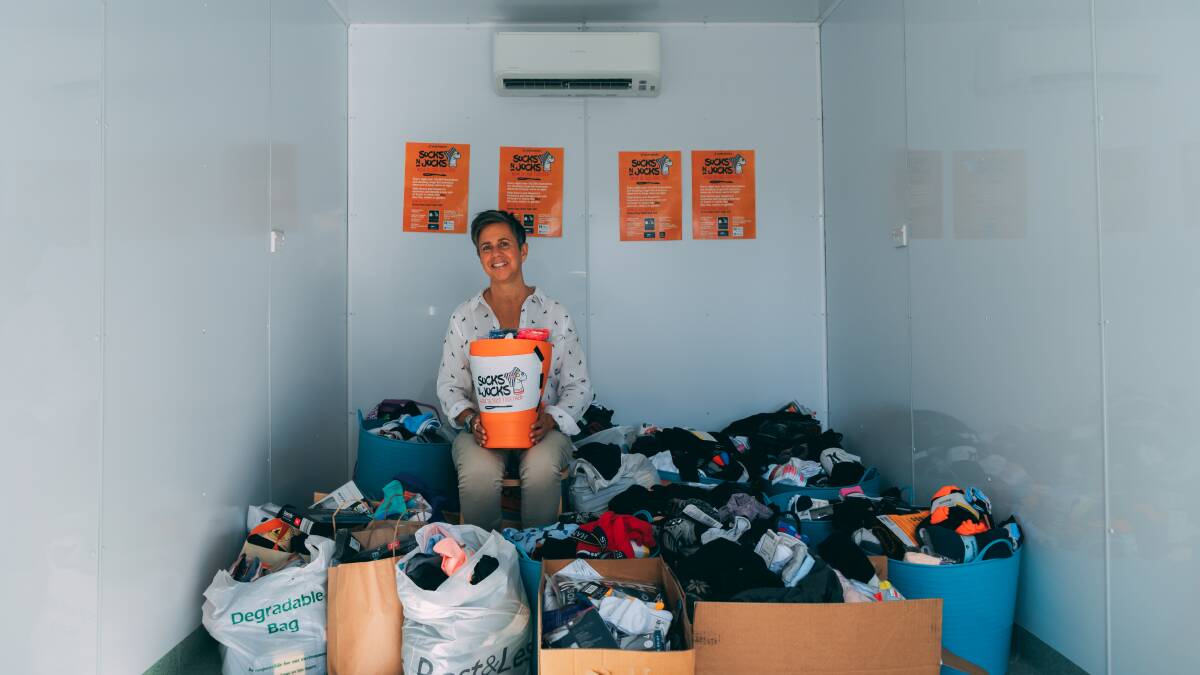 HELPING HAND: Organiser Grace Rey with some of the items collected as part of a previous 'Socks n Jocks' campaign. Picture: Supplied