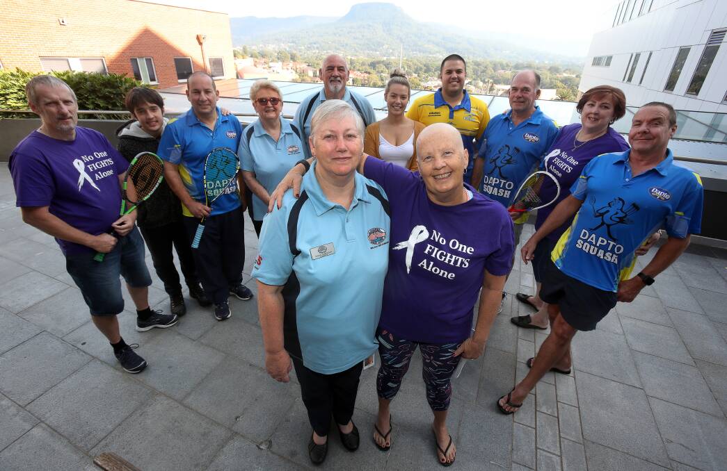 DONATION: Illawarra Cancer Carers president Sue Maidman and Carol Loy (front) with family and supporters on Saturday. Ms Loy raised more than $18,500, which was donated to the volunteer group. Picture: Robert Peet