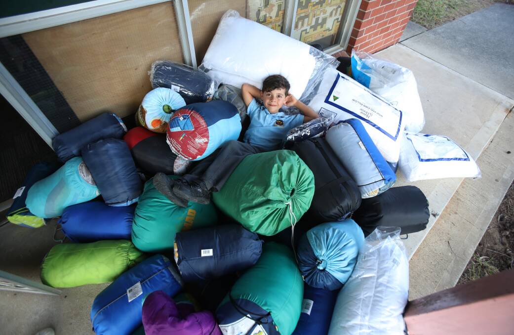GREAT EFFORT: Six-year-old Noah Harb from Bulli Public School, who has collected hundreds of sleeping bags and other items for the region's homeless. Picture: Robert Peet