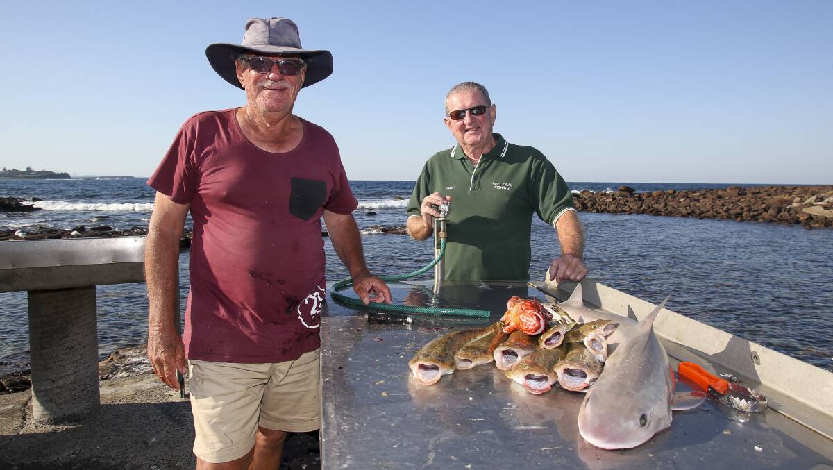 Anglers Robin Smith and Gary Wade at the Shellharbour boat ramp on Monday, discussing options for the next Offshore Artificial Reef. Picture: Anna Warr