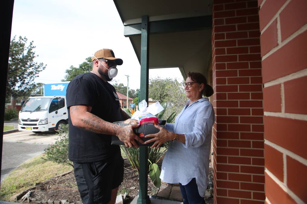 HELP: Aboriginal Elder Ruth Leon receives her items from Ali Maher at Primbee on Thursday. The items were delivered by the Illawarra Wingecarribee Alliance Aboriginal Corporation. Picture: Sylvia Liber